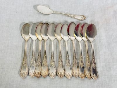 six spoons and a spoon with a spoon rest on a table