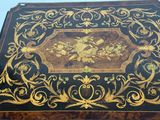 a black and gold box with a bird design on it