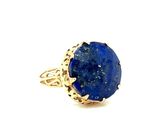 a close up of a ring with a blue stone in it