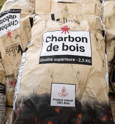 bags of charcoal are stacked on top of each other in a pile