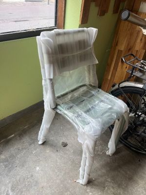 a plastic chair sitting in front of a bike
