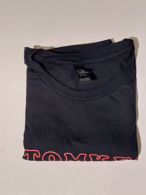 a black t - shirt with a red logo on the chest
