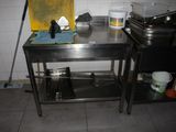 a kitchen with a stainless steel table and a stove