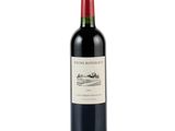 a bottle of red wine sitting on top of a white table