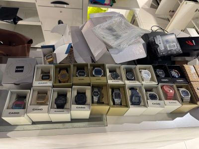 many boxes of watches sitting on a table in a store