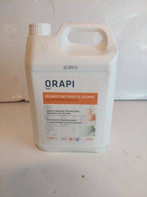 un récipient orange et blanc contenant un liquide, posé sur un plan de travail