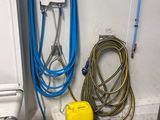 a yellow and blue hose next to a white wall