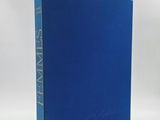 a blue book sitting on top of a white table
