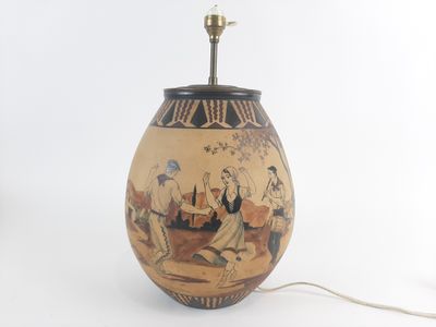a lamp that has a painting on it