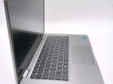 a silver laptop computer sitting on a white surface