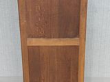 a small wooden cabinet with wheels on the floor