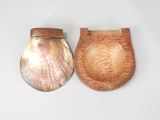 two pieces of wood and a shell on a table