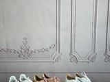 five pairs of sneakers lined up on a wooden table