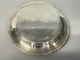 a silver plate with a lid on a white table