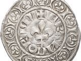an image of a silver coin with a fleur on it