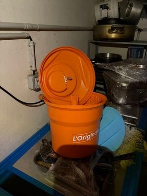 an orange bucket sitting on top of a blue table