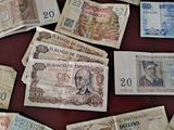 many different bank notes laid out on a table