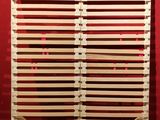 a close up of a wooden slatt with a red wall in the background