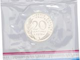a coin in a plastic bag with a ribbon around it