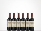 six bottles of red wine lined up on a table