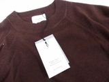 the sweater is brown and has a tag attached to it