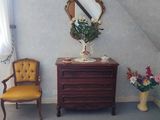 two chairs and a dresser in the corner of a room
