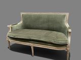 an image of a green couch sitting on top of a gray floor
