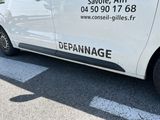 a white van that is parked on the side of the road