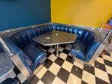a black and white checkered floor and a blue booth
