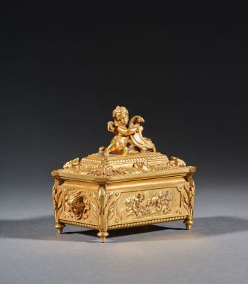 an antique gold casket with chers and angels on it