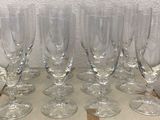 several empty wine glasses sitting on top of a wooden tray