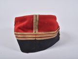 an image of a red and black hat with a gold stripe
