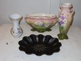 three vases and a bowl sitting on a table