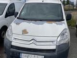a white van parked in a parking lot with other cars