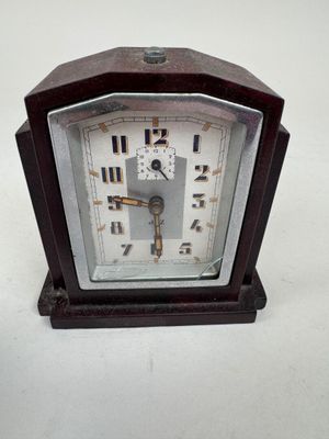 a small clock that is sitting on a table