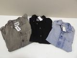 three pairs of men ' s shirts sitting on a white table
