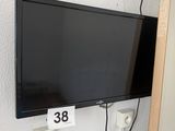 a flat screen tv mounted on the wall next to a door