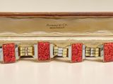 an image of a red and gold cuff bracelet in a case