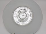 a close up of a white plate with a circular light on it