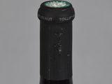 an old bottle of wine with a green label on it
