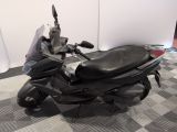 a scooter that is parked on a checkered floor