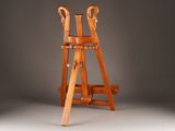 an old wooden easer with two legs and a wooden handle