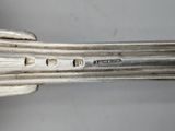 an image of a close up of a silver spoon with a handle