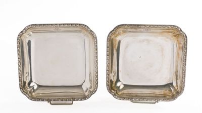 pair of antique silver plated dishes on stands on a white background