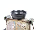 a vase with a rope around it on a white background