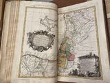 an open book with a map on it on a table