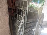 many chairs and a table in the corner of a room