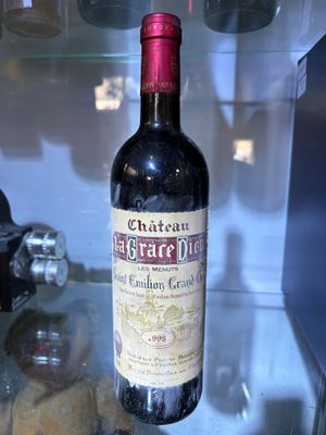 a bottle of wine on display in a glass case