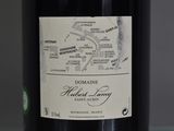 a bottle of wine sitting on a table with a map on it