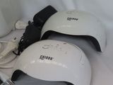 two electric nail dryers and a cup of water